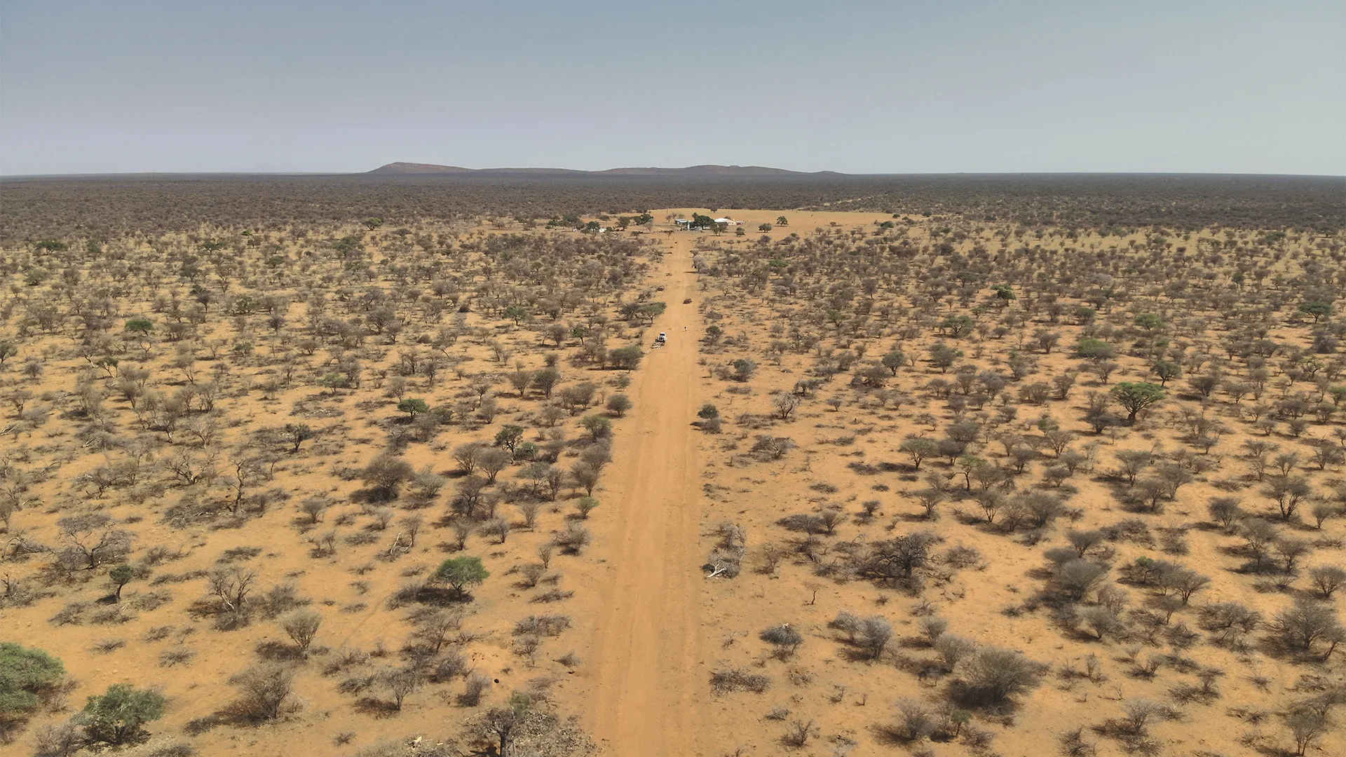 Aerial view of a farm track through dry bushland